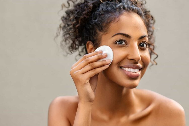 woman exfoliating her face